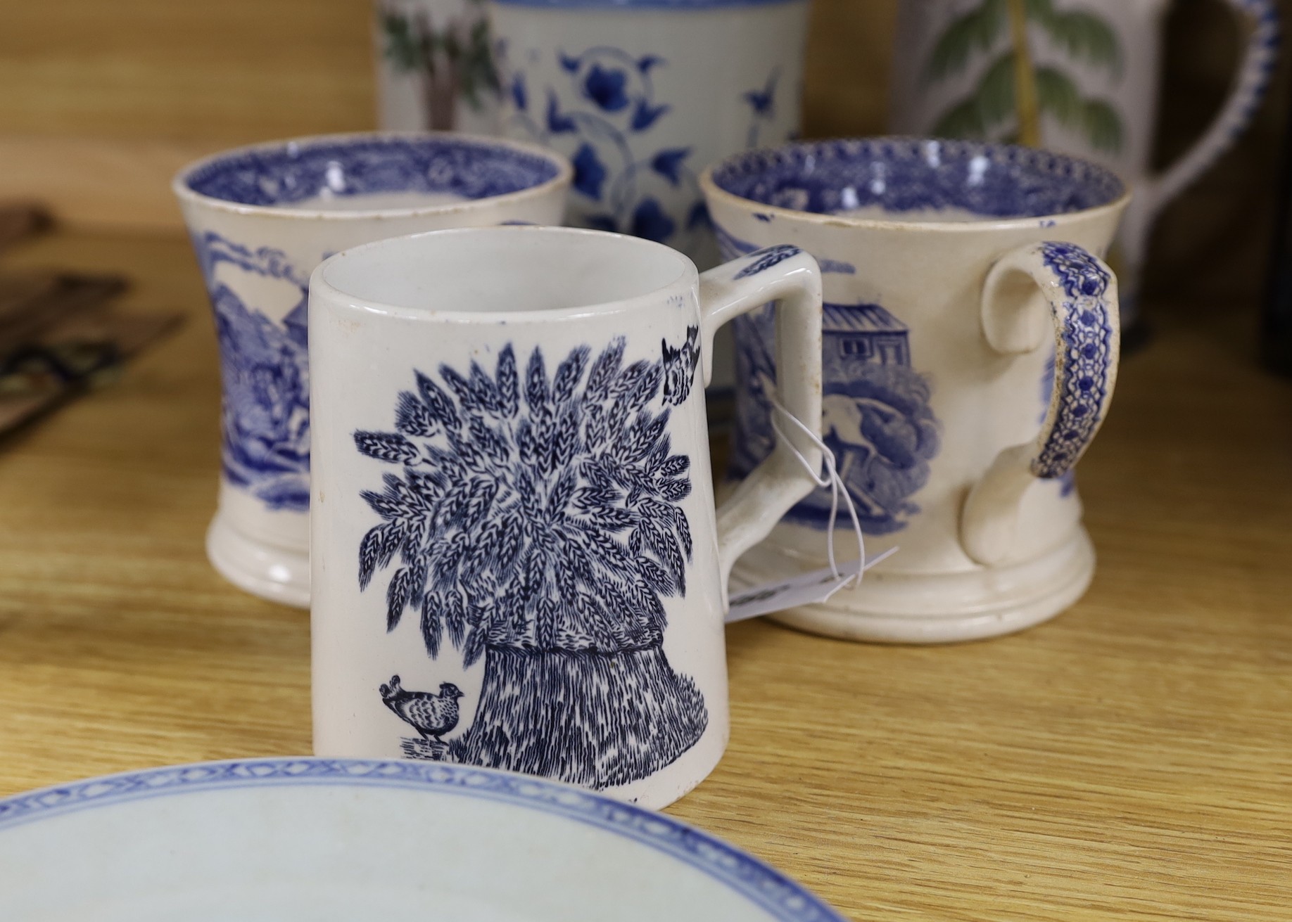A pair of German 17th century faience pewter mounted steins, together with a selection of blue and white ceramics, tallest 26cm